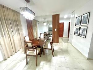 a dining room with a wooden table and chairs at Alojamiento San Isidro in La Grúa +11 photos