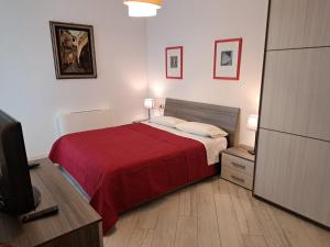 a bedroom with a bed with a red blanket at Your Comfort Home - Bologna in Bologna