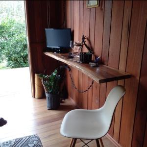 a wooden wall with a desk with a computer and a white chair at Cabana in Annitapolis