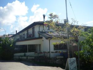 a white house with a balcony on top of it at Mamma Teresa in Sestola