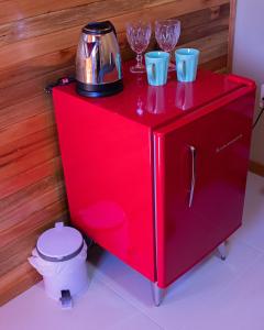 a red cabinet with glasses on top of it at Pousada da Gruta in Urubici +105 photos