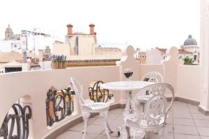 a table and chairs on a balcony with a view at Malaga Center Flat Luxury in Málaga