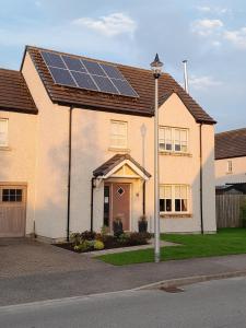 a house with a lot of solar panels on the roof at No1Dornoch in Dornoch