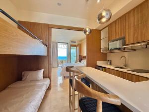 a hotel room with two beds and a kitchen at Zantamar Penthouse 603B, right on the beach in Cruz de Huanacaxtle