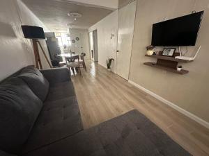 a living room with a couch and a flat screen tv at Casa Michel in Tepic