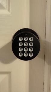 a light on a door with a bunch of buttons at K11 Private Room with Smart TV Near Everything in Orlando