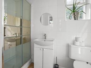 a white bathroom with a sink and a toilet at Gable End Coastal Retreat in Great Yarmouth