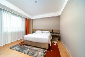 Letto o letti in una camera di Ronghuitong SSAW Hotel