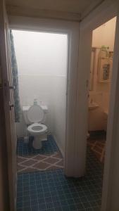 a bathroom with a white toilet in a room at The Wellstead in Cape Town