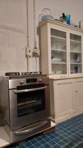 a kitchen with an oven and a cabinet at The Wellstead in Cape Town