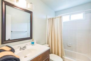 a bathroom with a sink and a toilet and a mirror at Parking,Pet,2bd,2b,WIFI,Smart TVs,Walk to Food,Fun in Long Beach +48 photos