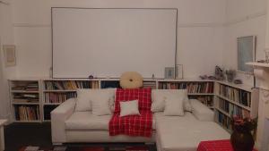 een woonkamer met een witte bank en een rode deken bij The Wellstead in Wynberg