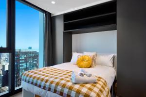 a bedroom with a bed with towels on it at Stay Fit & Relax - 2BR with Gym & Spa in Melbourne