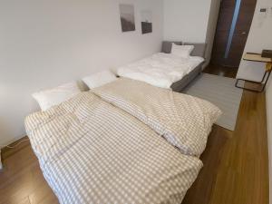 Postel nebo postele na pokoji v ubytování Suke Home Oshiage