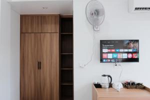 a room with a wooden cabinet and a fan at Homestay SkyLight in Dong Hoi