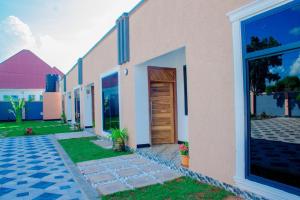 a house with a wooden door and a yard at One bedroom Dodoma in Dodoma