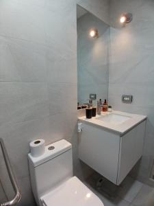 a bathroom with a white toilet and a sink at Departamento Increible -Trujillo in Trujillo +24 photos