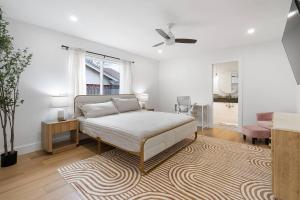 a white bedroom with a bed and a rug at Stylish Austin Escape 4BR, 2BA, Minutes from Domain, Q2 Stadium in Austin