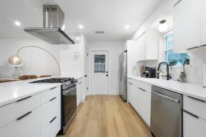 a kitchen with white counters and a stove top oven at Stylish Austin Escape 4BR, 2BA, Minutes from Domain, Q2 Stadium in Austin