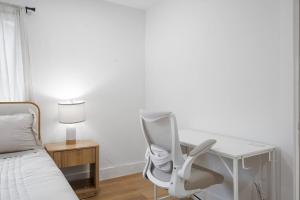 a bedroom with a desk and a chair next to a bed at Stylish Austin Escape 4BR, 2BA, Minutes from Domain, Q2 Stadium in Austin