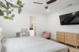 a bedroom with a bed and a flat screen tv at Stylish Austin Escape 4BR, 2BA, Minutes from Domain, Q2 Stadium in Austin