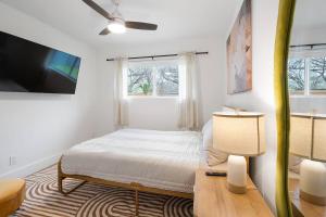 a bedroom with a bed and a desk and a tv at Stylish Austin Escape 4BR, 2BA, Minutes from Domain, Q2 Stadium in Austin