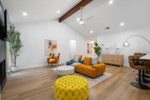 a living room with a yellow couch and a table at Stylish Austin Escape 4BR, 2BA, Minutes from Domain, Q2 Stadium in Austin