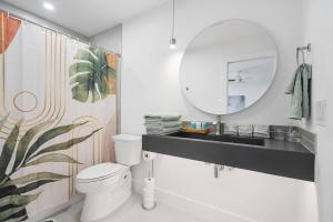 a bathroom with a white toilet and a mirror at Stylish Austin Escape 4BR, 2BA, Minutes from Domain, Q2 Stadium in Austin