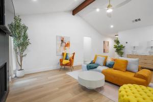 a living room with a yellow couch and a table at Stylish Austin Escape 4BR, 2BA, Minutes from Domain, Q2 Stadium in Austin