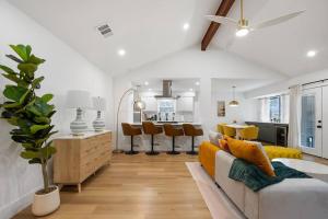 a living room and kitchen with a couch and a table at Stylish Austin Escape 4BR, 2BA, Minutes from Domain, Q2 Stadium in Austin