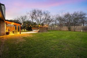 a backyard of a house with a grass yard at Stylish Austin Escape 4BR, 2BA, Minutes from Domain, Q2 Stadium in Austin