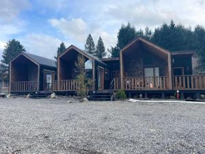 a couple of log cabins in a parking lot at Nevada Malalcahuello in Malalcahuello