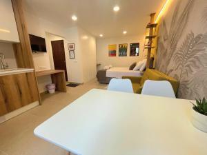 a living room with a white table and a bedroom at Botique Studio - Casa El Sueño II in Vodnjan