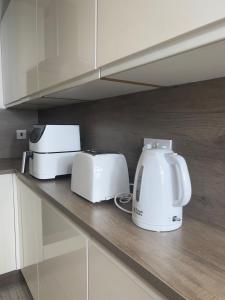 two toasters and a toaster on a kitchen counter at Long Stay Basildon Essex Business Contractors in Basildon