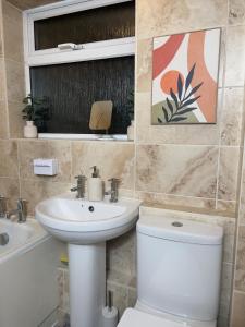 a bathroom with a toilet and a sink at Long Stay Basildon Essex Business Contractors in Basildon
