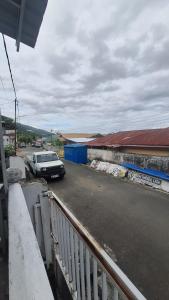 a car parked on the side of a street at 88HappyHomestay in Luwuk +2 photos