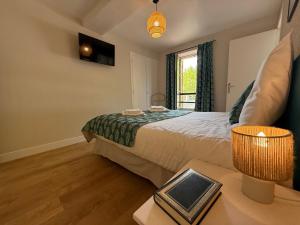 una camera da letto con un letto e un tavolo con una lampada di Studio Charmant au Coeur d'Excideuil - Animaux Bienvenus - FR-1-839-6 a Excideuil