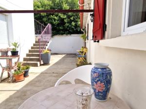 a vase sitting on a table on a patio at Appartement climatisé au cœur de Banyuls-sur-Mer, proche plage - FR-1-309-525 in Banyuls-sur-Mer