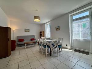 a living room with a table and chairs and a couch at Maison calme Saint-Denis d'Oléron proche centre et plage - FR-1-246A-364 in Saint-Denis-dʼOléron +10 photos
