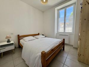 a bedroom with a large bed and a window at Maison calme Saint-Denis d'Oléron proche centre et plage - FR-1-246A-364 in Saint-Denis-dʼOléron