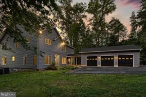 a house with a garage and a house at Lka Luxury Sandy Beach, Sauna, Hot Tub, Firepit in Bumpass