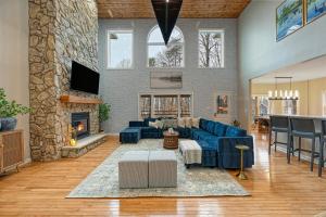 a living room with a blue couch and a fireplace at Lka Luxury Sandy Beach, Sauna, Hot Tub, Firepit in Bumpass