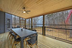 a dining room with a table and chairs on a deck at Lka Luxury Sandy Beach, Sauna, Hot Tub, Firepit in Bumpass