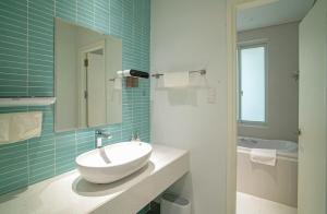 a bathroom with a sink and a mirror and a tub at Aries's House, Villa 4BR Near the Sea, Right in the Center in Da Nang +24 photos