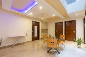 a room with a table and chairs and a ceiling at Windchime 331 in Gurgaon