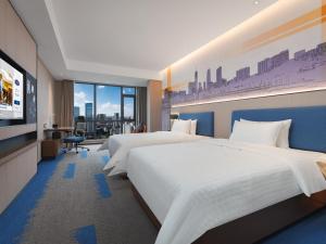 Postel nebo postele na pokoji v ubytování Hampton by Hilton Dongguan Fenggang