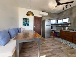 a kitchen and living room with a table and a couch at Casa Mantra Ocean View & Private Terrace in La Ventana