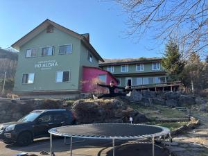 a man is jumping over a trampoline on a trampoline at Guesthouse HOALOHA 4 SEASONS in Chino