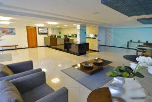 a living room with a couch and a table at Loft 306 Imperial Suites in João Pessoa +69 photos
