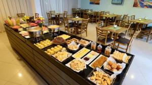 a buffet with many different types of food on display at Loft 306 Imperial Suites in João Pessoa